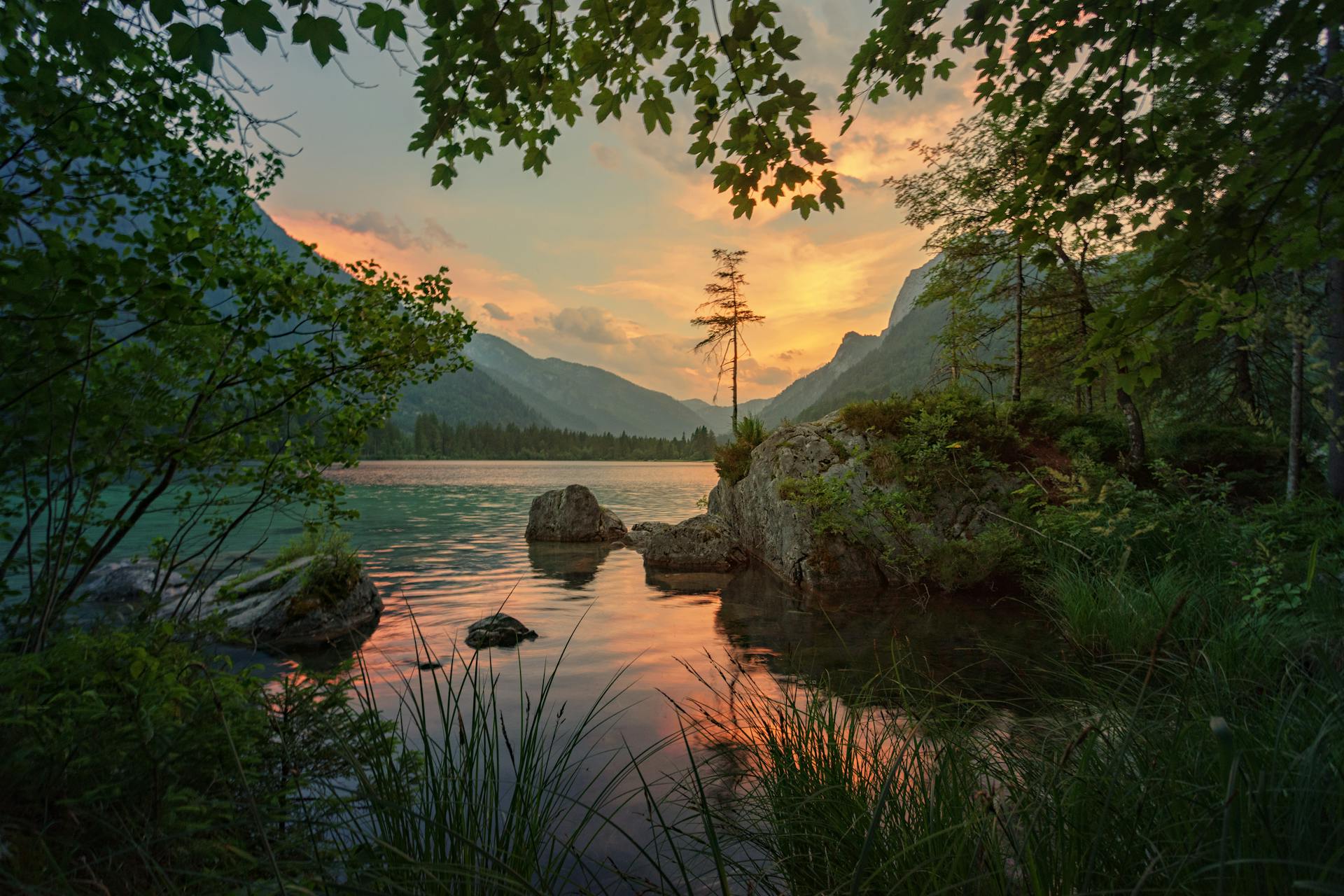 Serene lake at sunset with a backdrop of distant mountains, symbolising the journey of 'Finding Purpose Lately'. The calm waters and tranquil setting reflect deep introspection and personal growth.