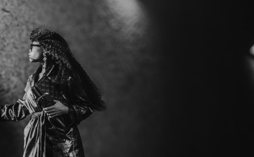 Bess Obarotimi standing in soft light, symbolising reflection and the inner journey of shadow work and self-growth.