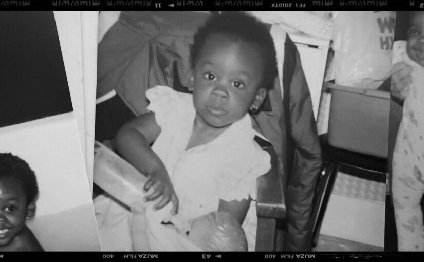 A black-and-white childhood photo of a young girl holding a bottle, used as the hero image for the story She Used to Talk to Herself — a story about loneliness and finding her voice.