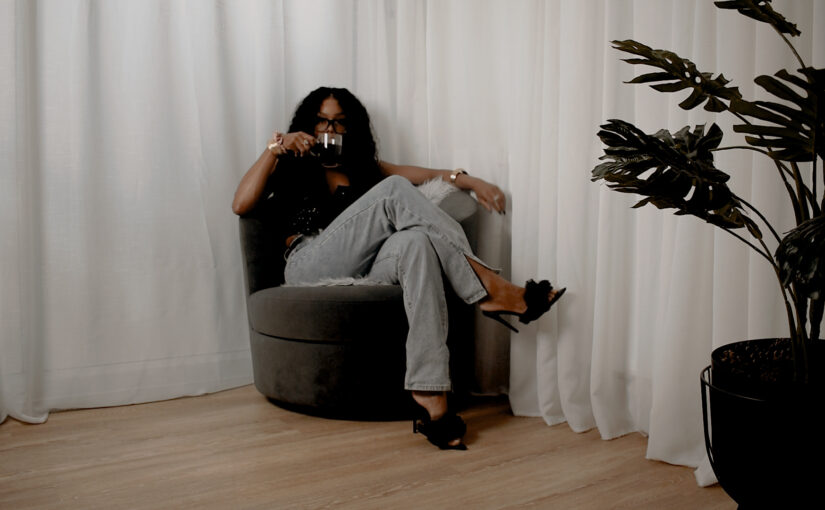 A reflective moment of Bess Obarotimi drinking coffee, symbolising the pause before a spiritual identity shift.