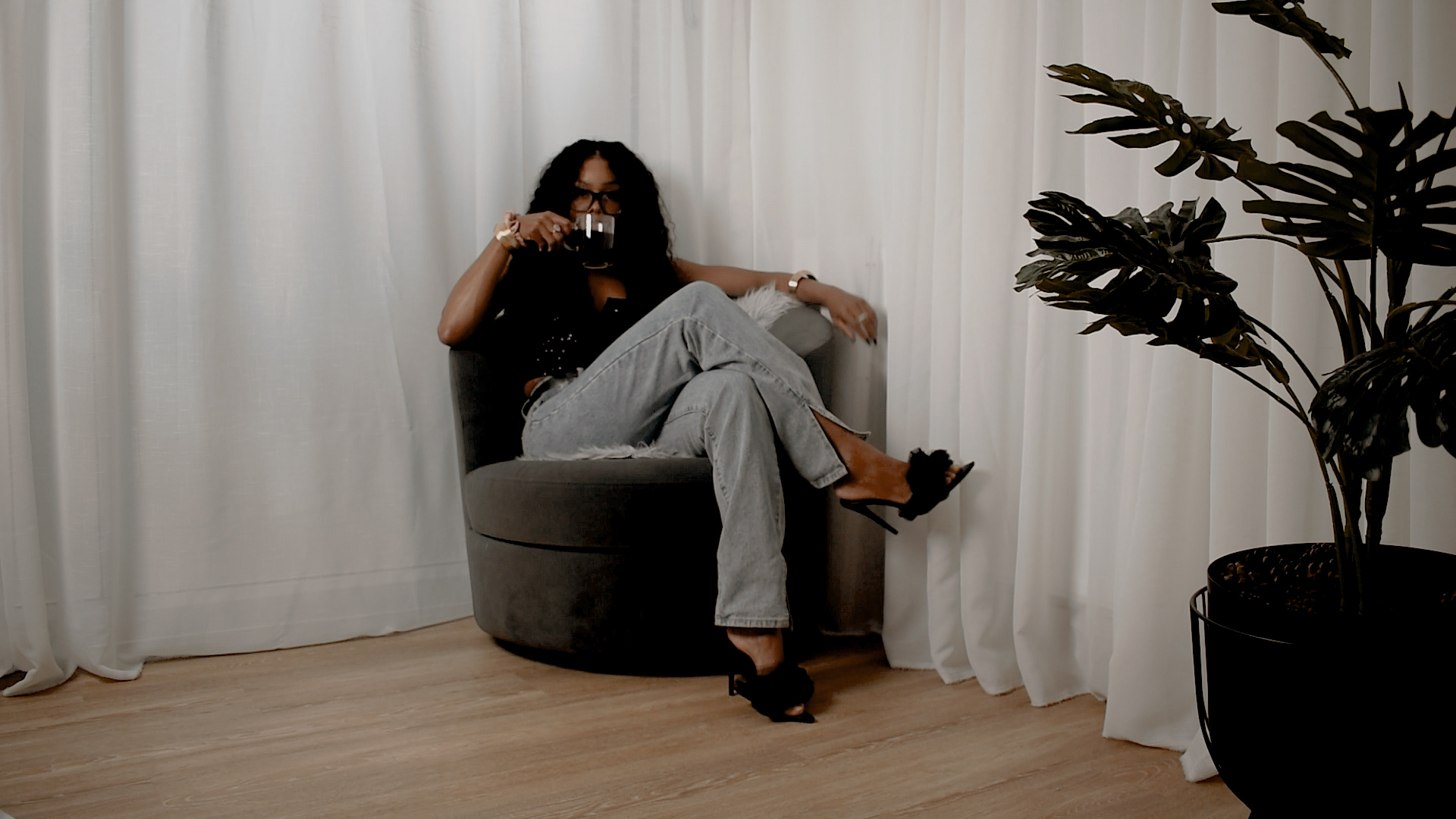 A reflective moment of Bess Obarotimi drinking coffee, symbolising the pause before a spiritual identity shift.