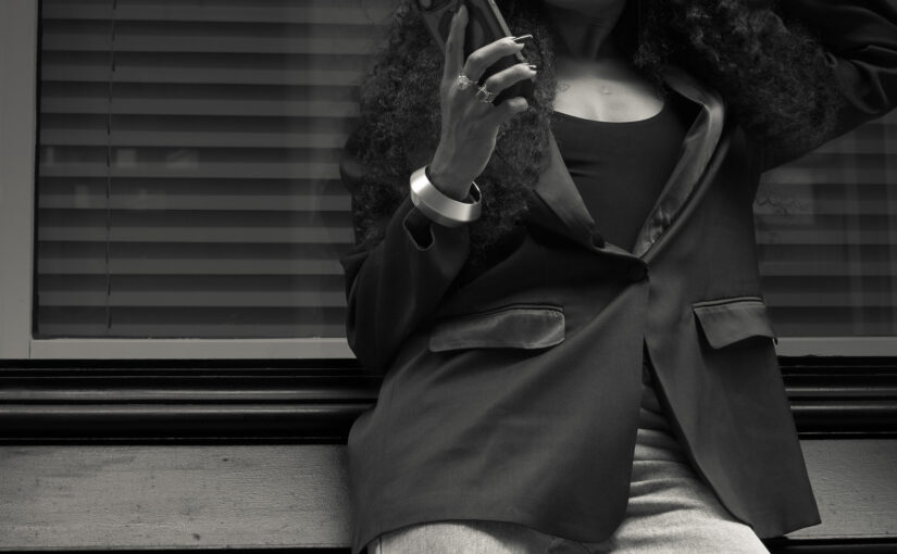 Bess Obarotimi standing outdoors in a confident street-style portrait, reflecting on the identity shift for success.