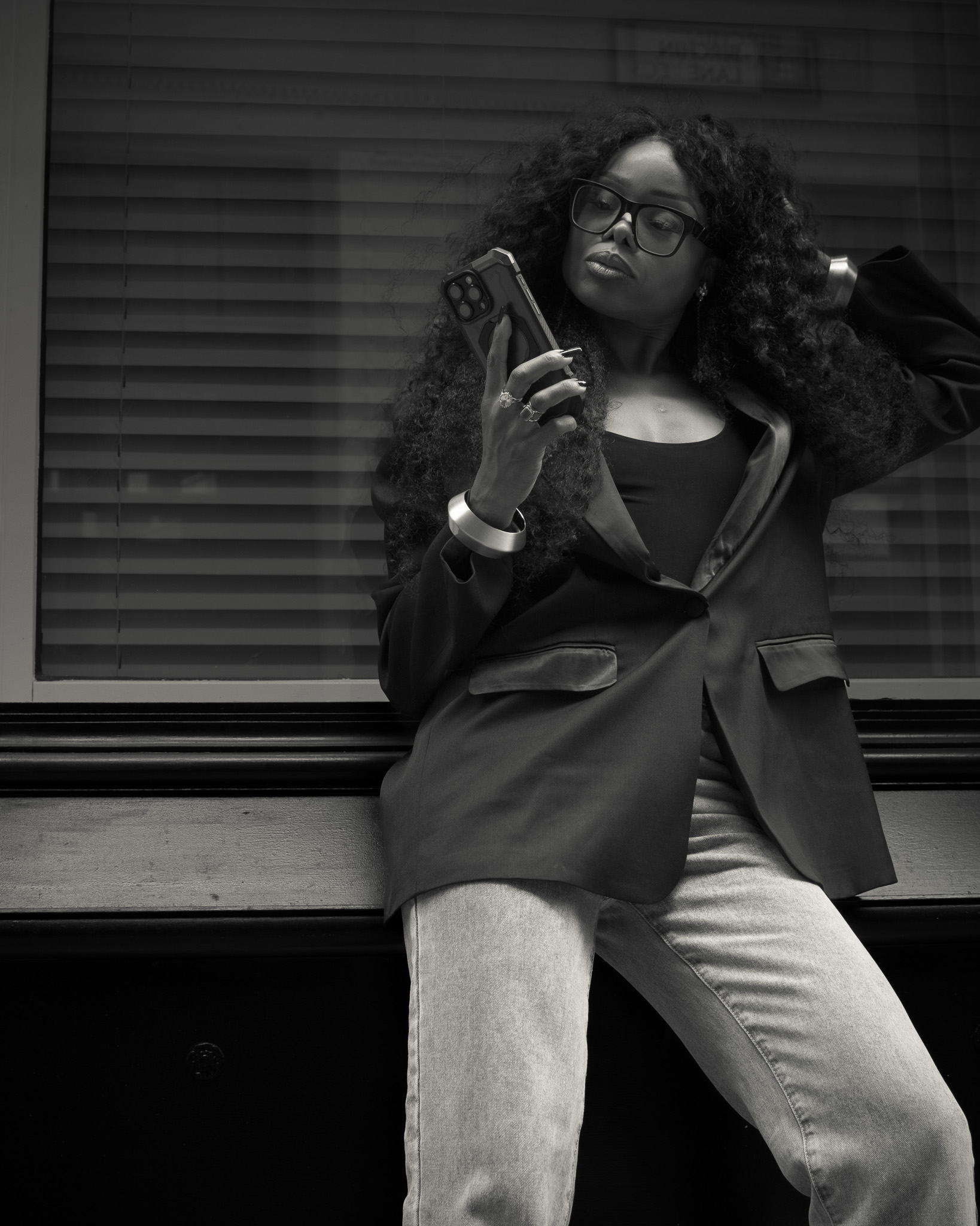 Bess Obarotimi standing outdoors in a confident street-style portrait, reflecting on the identity shift for success.