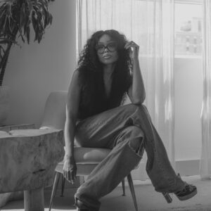 Bess Obarotimi seated in a calm, reflective space for A Conversation With Bess clarity session.