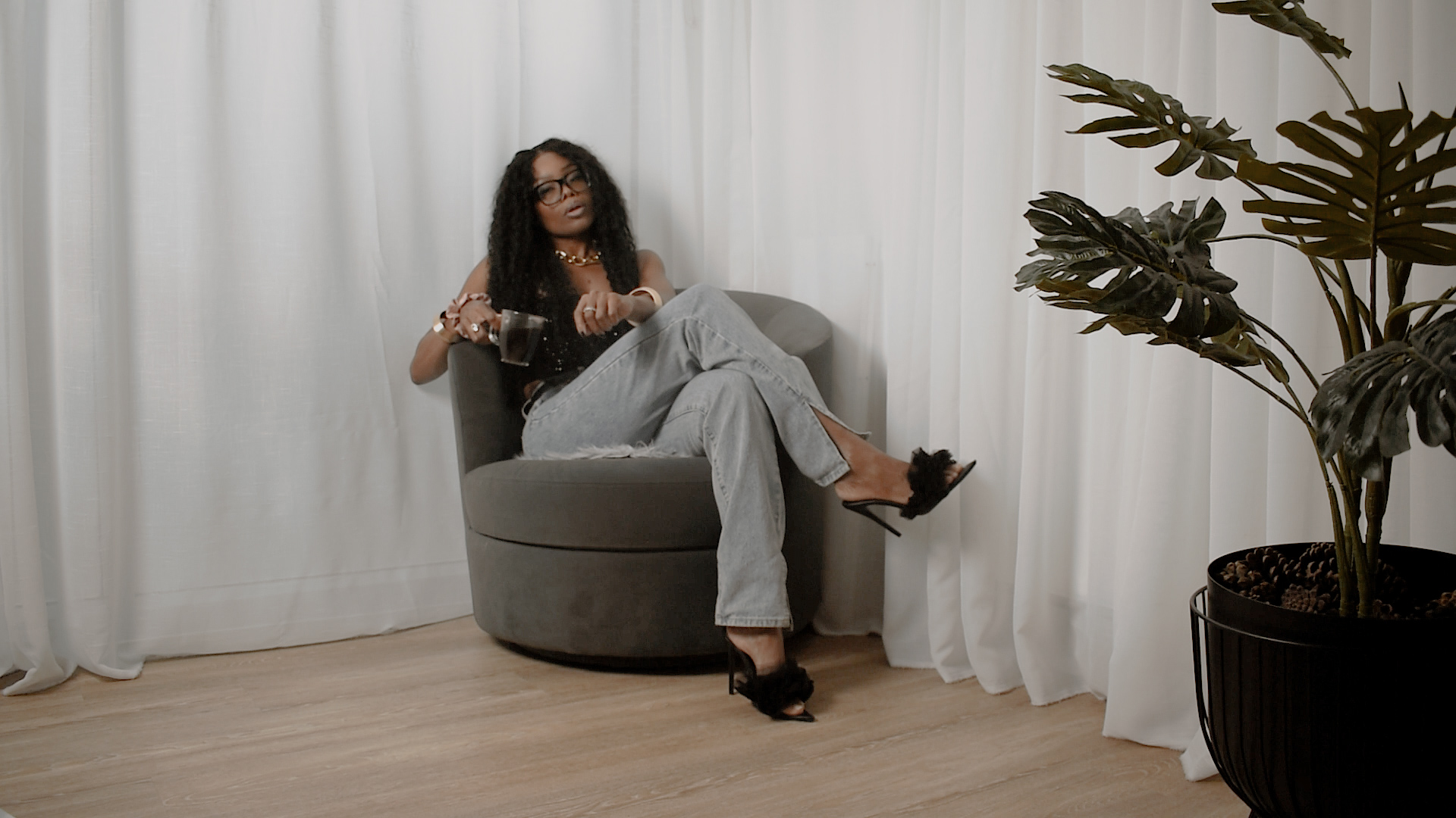 Bess Obarotimi seated in a calm, minimalist space, speaking on why presence is the new productivity during the I AM Success Mini-Series