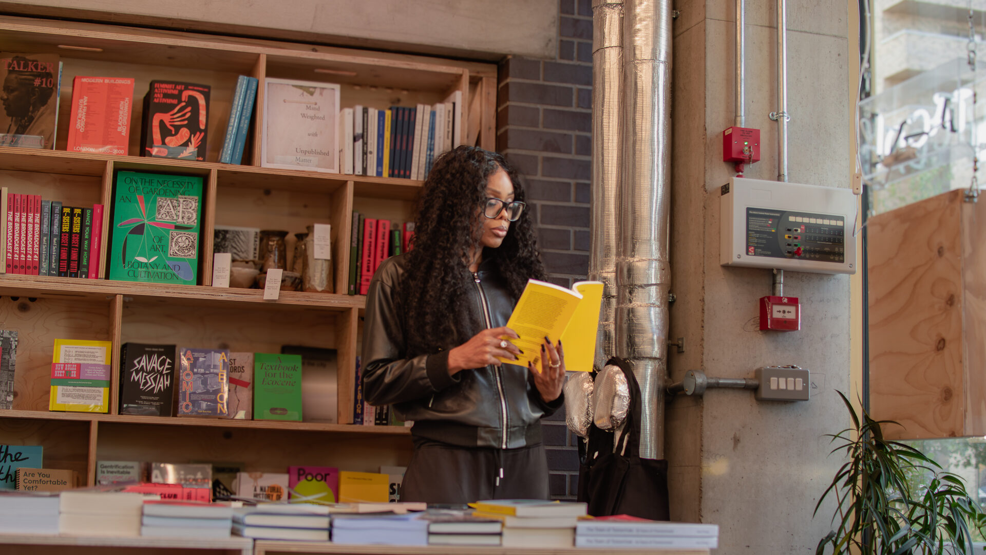 Bess Obarotimi reading in a bookshop while reflecting on decision authority and organisational governance
