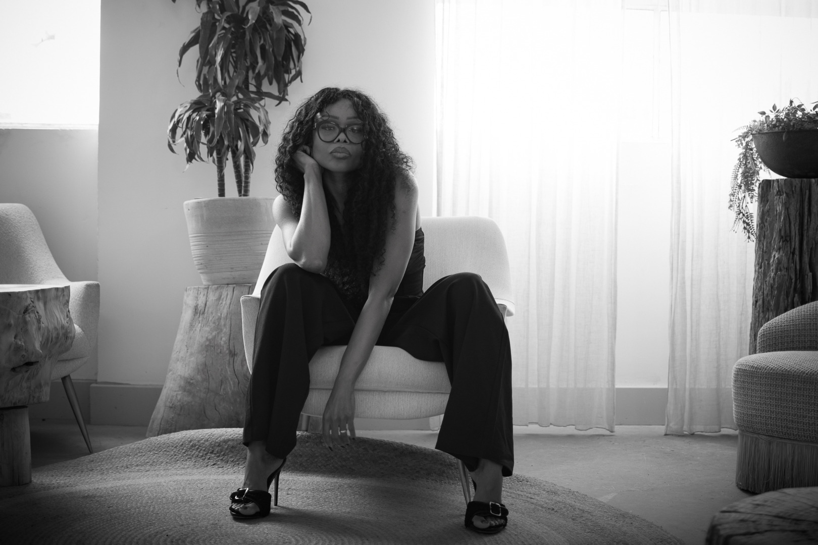 Black-and-white portrait of a woman seated in an armchair for the AI governance commentary Who Can Actually Stop the AI?
